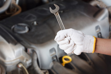 Hand of auto mechanic with wrench