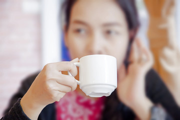 coffee cup in hand asian woman., in the morning at restaurant.