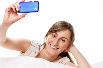 Naklejka premium smiling girl taking photo herself her mobile phone