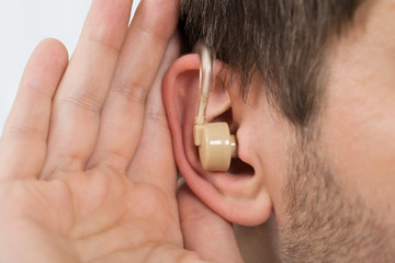 Fototapeta premium Close-up Of Man Wearing Hearing Aid In Ear