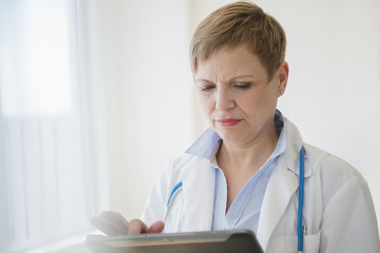 Caucasian doctor using digital tablet