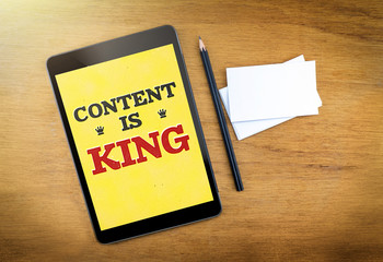 Content is king on mobile device screen with pen and business ca