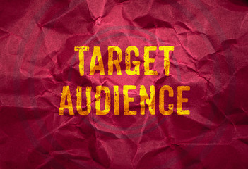 Target Audience in gold texture on crumpled red paper background