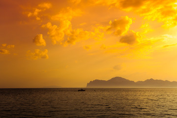 Naklejka na ściany i meble Beautiful golden sunset over rocky sea coast