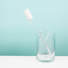 The clear toothbrush with small glass for brushing the teeth.