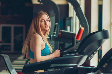 Fototapeta premium Shot of a girl running on the treadmill