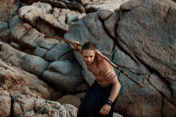 Tribal warrior. Young attractive man outdoor