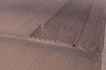 Fototapeta na wymiar aerial view of tractor on harvest field