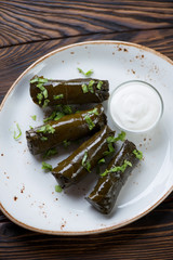 Glass plate with dolma or stuffed vine leaves, high angle view