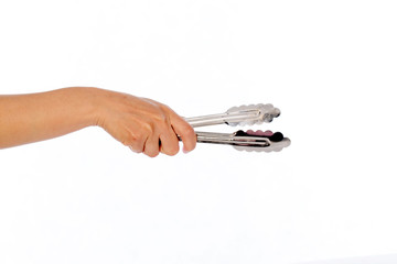 hand use tongs on white background, selective focus