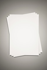 Paper stacked on grey background