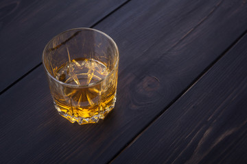 Whiskey on dark wood