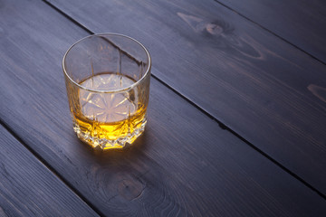 Whiskey on dark wood