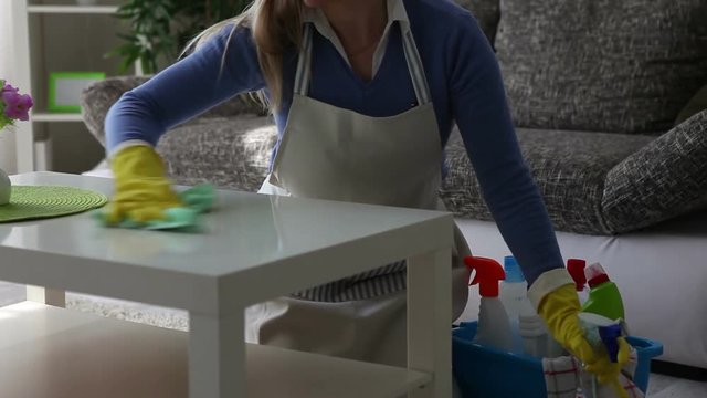 Young happy woman cleaning  the table close-up
