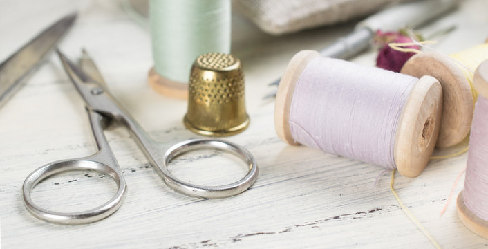 Golden thimble with set of reel of thread, scissors for sewing a