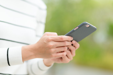 Woman send text message on mobile phone