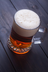 Mug of beer on wood