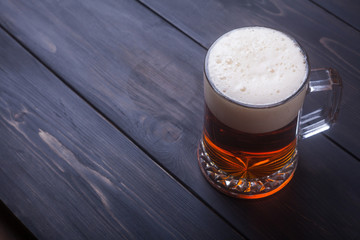 Mug of beer on wood