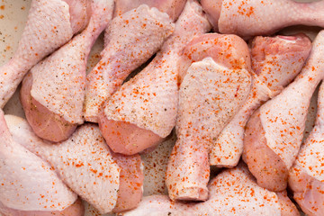 Fresh chicken leg,  meat on plate.With spices.