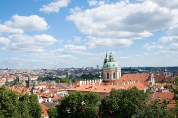 Obraz premium Church St. Nicholas and roofs Mala Strana from garden of Prague castle, Prague , Czech republic