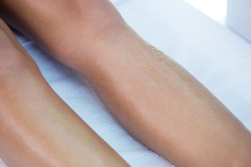 Woman getting her legs waxed 