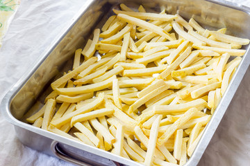 Baking pan of chips to be cooked in the oven