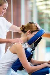 Woman receiving massage in massage chair