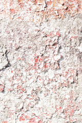 cement surface with peeling red paint