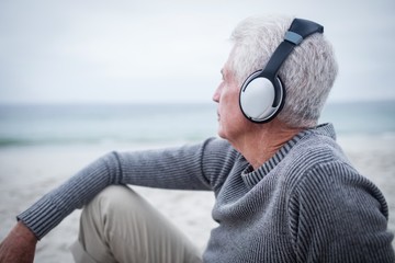 Senior man listening to music on headphone