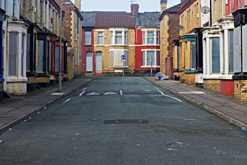 A street of boarded up derelict houses awaiting regeneration in Liverpool UK - 107503964