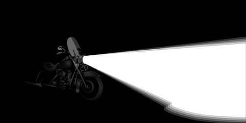 Heavy touring motorcycle headlight on a night road