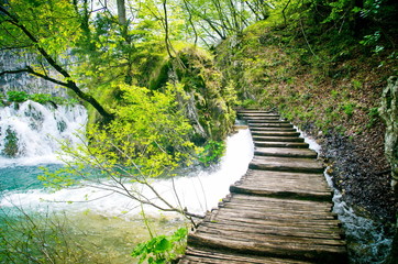 Beautiful nature spring. Wooden path and waterfall in Plitvice National Park, Croatia
