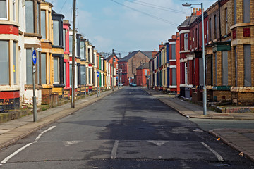 A street of boarded up derelict houses awaiting regeneration in Liverpool UK - 107505334