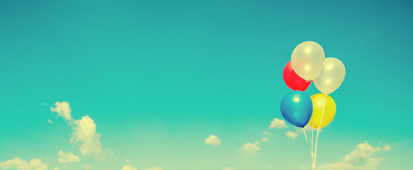 Colourful balloon on blue sky with tinny clouds background,Panoramic cover or banner background.vintage tone