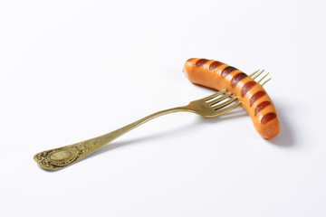 Grilled sausage on fork