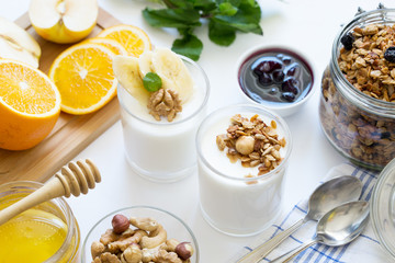 Healthy breakfast with yogurt in glass, granola and fruits