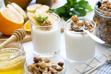 Healthy breakfast with yogurt in glass, granola and fruits