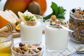 Healthy breakfast with yogurt in glass, granola and fruits