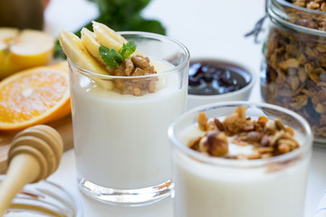 Healthy breakfast with yogurt in glass, granola and fruits
