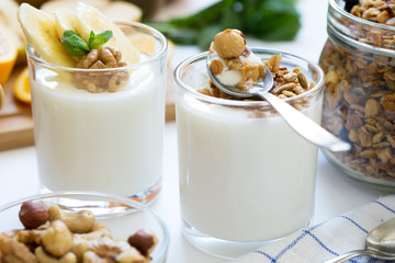 Healthy breakfast with yogurt in glass, granola and fruits