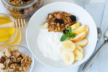 Healthy breakfast bowl with yogurt and granola. Top view