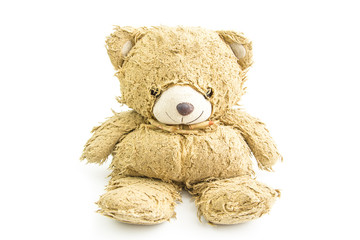 Old teddy bear with bow isolated.