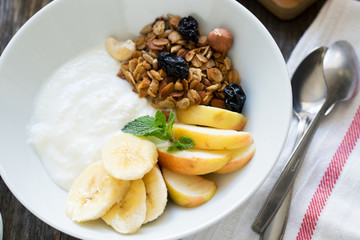 Healthy breakfast bowl with yogurt and granola. Top view