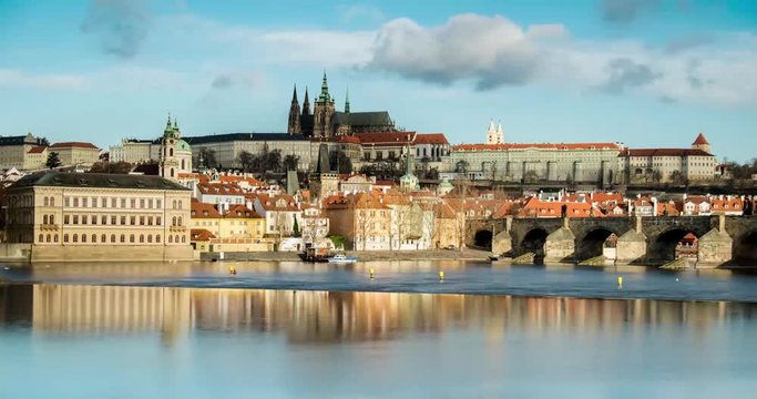 Clouds flying over St. Vitus Cathedral, Prague castle and Charles Bridge in Prague, Czech Republic. 4k time-lapse video