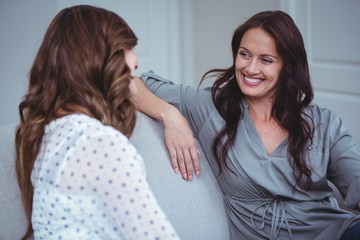 Two beautiful woman interacting with each other