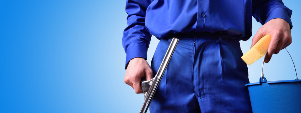 Window cleaning employee with work tools blue background