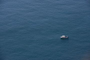 Boat is on background of rippled surface of sea.