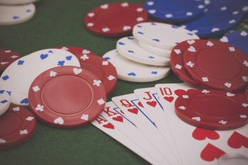 Poker chips and cards on a green table