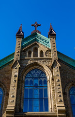 Fototapeta na wymiar Blue Window at Top of Church