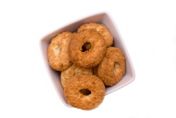 Cookies on a square bowl on a white background seen from above